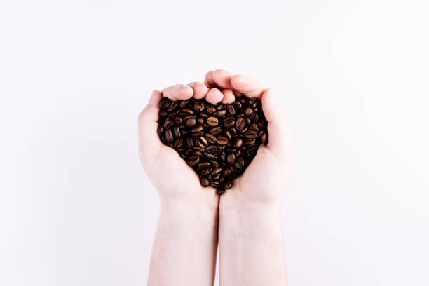 両手のコーヒー豆 - barista coffee coffee crop heart shape ストックフォトと画像