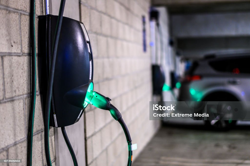 Power supply box in an electric vehicle charging station at a parking lot Power supply box in an electric vehicle charging station parking lot in a public garage. Electric Vehicle Charging Station Stock Photo