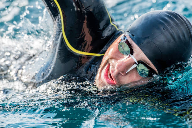 istock Male swimmer inhaling while freestyle swimming 1073406226