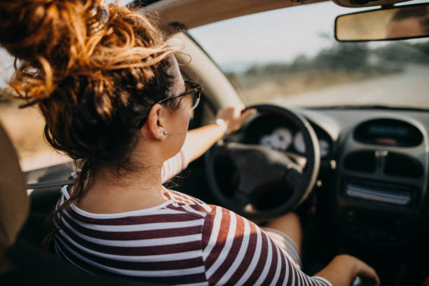 istock Young women on a road trip with cabriolet 1073409728