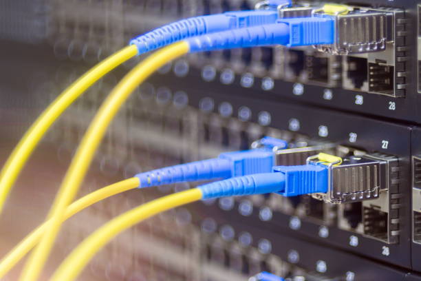 istock Two pairs of fiber optic patch cords are connected to a manageable Internet switch. Server hardware datacenter. The concept of high-speed data transfer and modern Internet technologies. Selective focus 1073415108