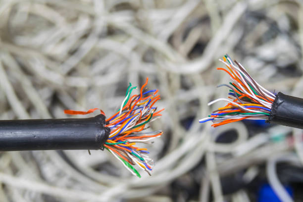 istock Disconnect. Breakdown of communication equipment. A damaged multi-core cable is shown close-up. Breakage of the telephone wire. Problems with telecommunications Internet connection. 1073415178