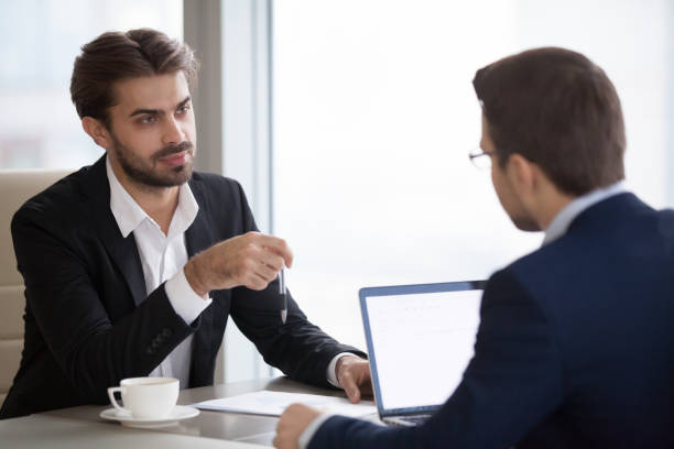 istock Two men in suits are talking in the office 1073415874