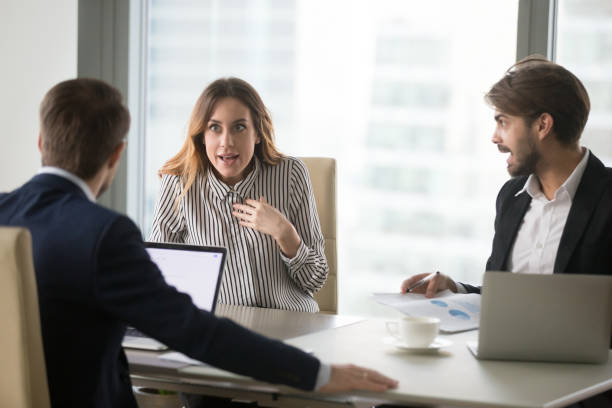 istock Angry man shouting at indignant female colleague. 1073416006