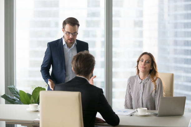 istock Dissatisfied man shouting at employee, trainee, blaming. 1073416026