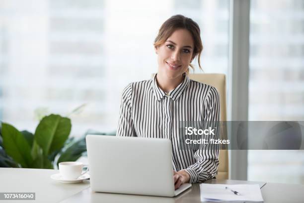 Head Shot Portrait Of Confident Businesswoman At Workplace Stock Photo - Download Image Now