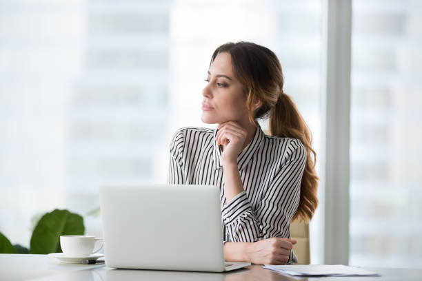 istock Focused pensive young woman looking in distance. 1073416042