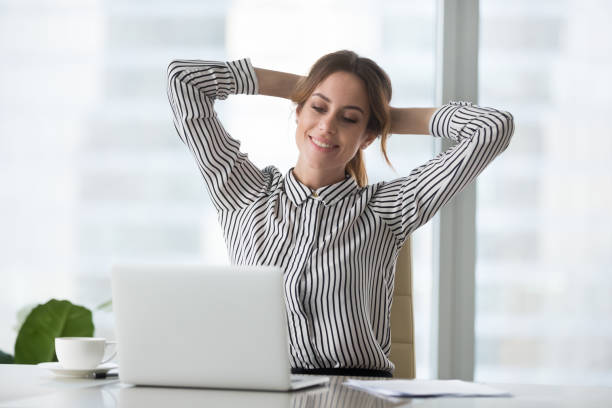 istock Satisfied woman relaxing with hands over head. 1073416048