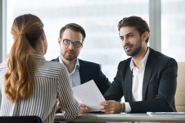 istock Two male hr managers at interview with female applicant. 1073416070