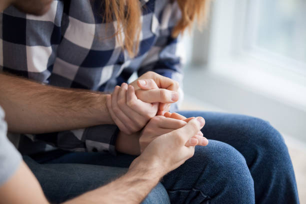 Couple holding hands, showing love and empathy close up Couple holding hands, consoling, showing love and empathy close up. Husband support, understanding, care wife. Overcoming problems, saying sorry, good relationships interrogation woman stock pictures, royalty-free photos & images