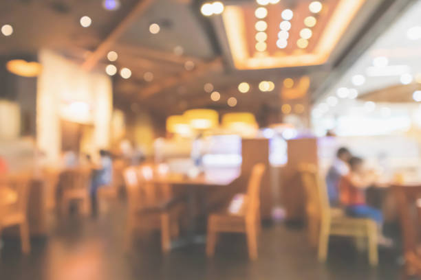 istock Restaurant interior with customer and wood table blur abstract background with bokeh light 1073416280