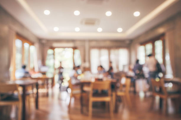 istock Restaurant interior with customer and wood table blur abstract background with bokeh light 1073416286
