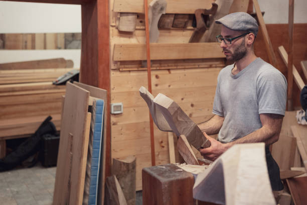 istock Carpentry worker looking at wooden detail 1073416474