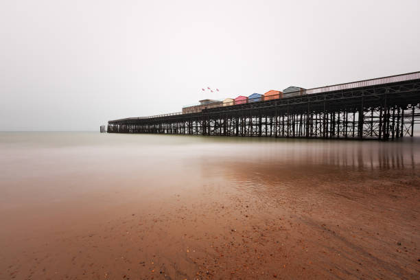 Hastings Pier in winter with an overcast sky and slow shutter speed