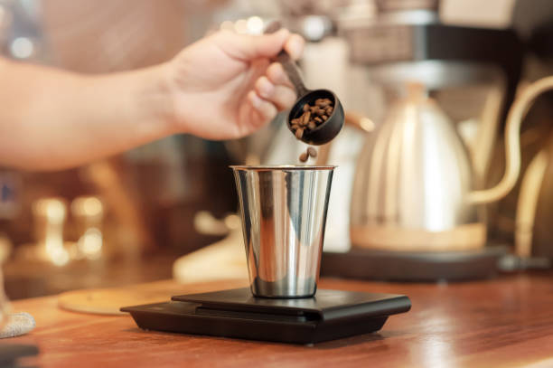 istock Barista hand pouring fresh roasted coffee beans 1073416708