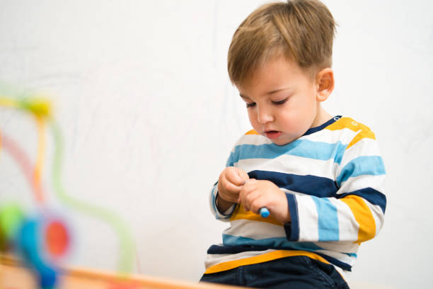istock Baby Boy Playing WIth Crayons 1073422416