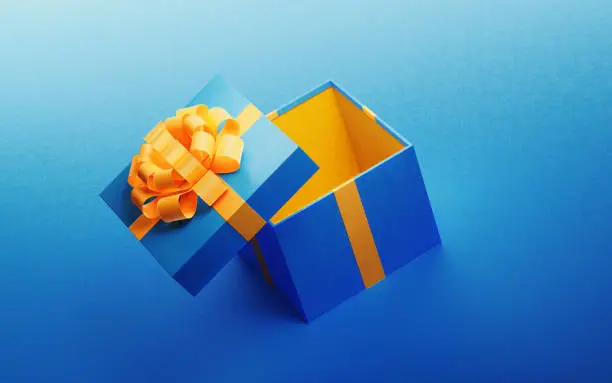 Photo of Open Blue Gift Box Tied With Yellow Ribbon