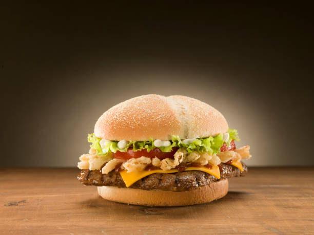 istock Cheese burger on wooden table. 1073425952