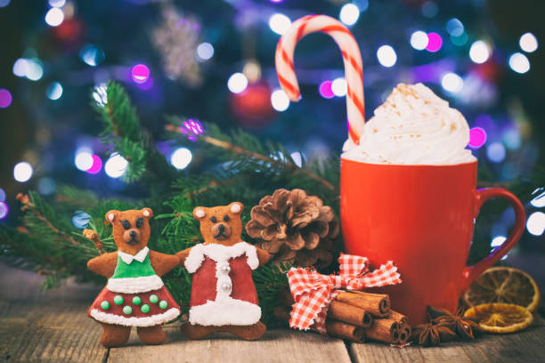 istock Christmas cappuccino and gingerbread homemade cookies in front Christmas tree on Rustic Wooden Table 1073432656