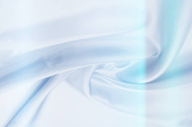 istock Background pattern, texture. Silk fabric of blue tones. Fine silk - top view - close-up of a thin silk surface shadow color serenity - pastel tone. Blue wrinkled fabric tissue background 1073441164
