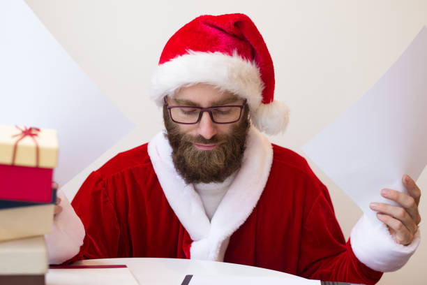 istock Serious man wearing Santa costume and raising documents 1073442872