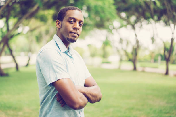 istock Ambitious confident young black man with beard in summer park 1073444758