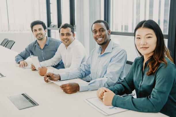 istock Smiling multiethnic managers working with charts in board room 1073454716