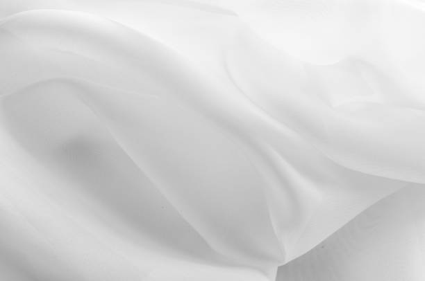 istock Texture, background, pattern. Silk fabric is transparent, white in color. Abstract soft chiffon texture background. Soft white chiffon with curve and wave 1073454890