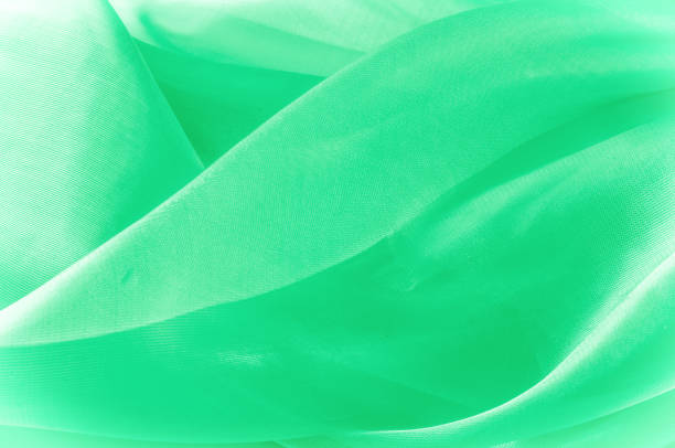 istock Texture, background, pattern. Green silk fabric for draping. Abstract Fabric, Artistic Waving Cloth Fractal Pattern 1073455052