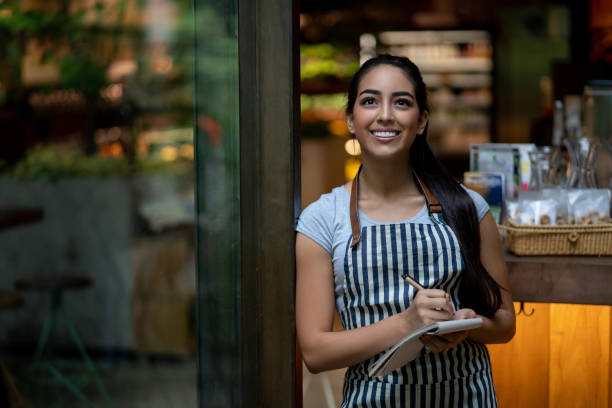 istock Beautiful young waitress looking up thinking while smiling very happy 1073458306