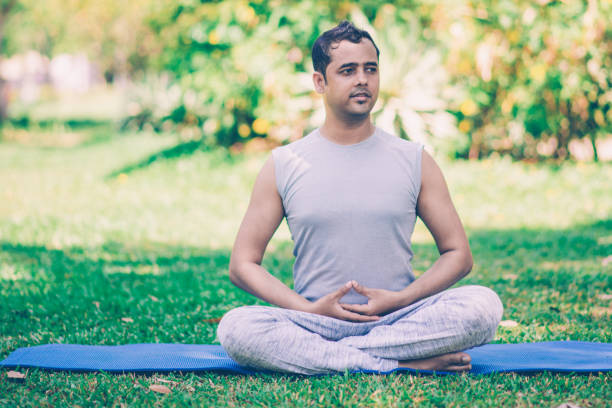 istock Pensive office worker starting his weekend with yoga 1073461004