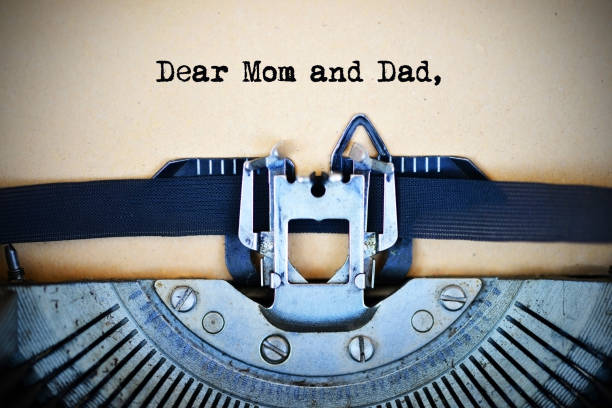 istock Letter for parents beginning with Dear mom and dad text typed by vintage typewriter machine 1073461486