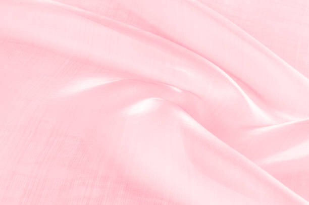 istock Background texture, pattern. Cloth pink silk. Smooth elegant pink silk or satin can use as wedding background. Luxurious valentine day background design. 1073467746