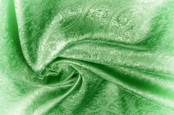 istock Background texture, pattern. Paisley Silk green Jacquard is a complex woven glossy fabric with a woven design. Weaving creates the effect of a 