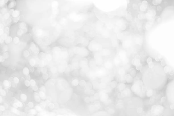 istock Abstract glamorous white and silver bokeh lights glitter sparkle. Defocused background have luxury golden color party invite for birthday, anniversary, holliday, new year xmas or snow christmas blur. 1073478840
