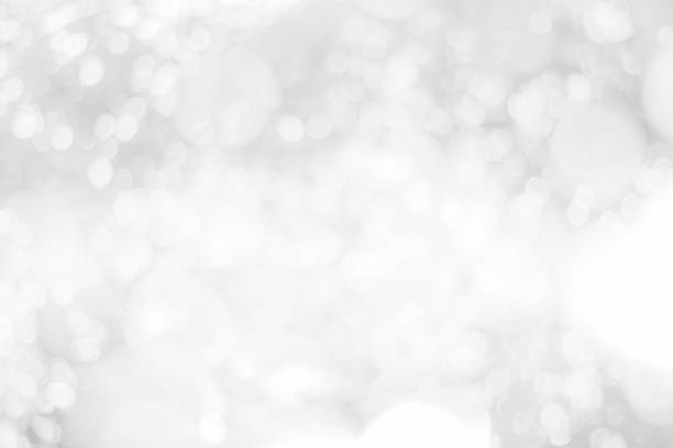 istock Abstract glamorous white and silver bokeh lights glitter sparkle. Defocused background have luxury golden color party invite for birthday, anniversary, holliday, new year xmas or snow christmas blur. 1073478864