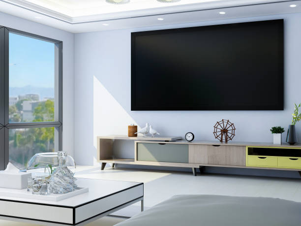 istock Spacious and bright modern living room design with TV, sofa and coffee table, sunlight shining into the room through huge glass windows 1073492696