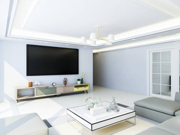istock Spacious and bright modern living room design with TV, sofa and coffee table, sunlight shining into the room through huge glass windows 1073492728