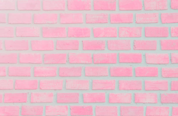 istock Wall stained old grungy stucco texture background. Brickwork flooring interior rock old pattern clean concrete have grid uneven design stack. Abstract kitchen wallpaper modern pink brick tile. 1073501824