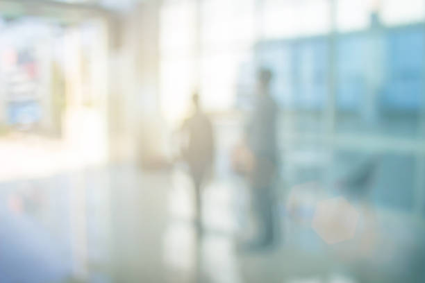 istock Businessmen blur in the workplace or work space of table in office room with computer or shallow depth of focus of abstract background. Business blur interior in hospital have modern commercial hall. 1073502144