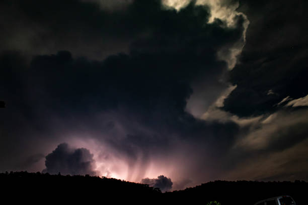 istock Lightning Behind the Mountain at night 1073512376