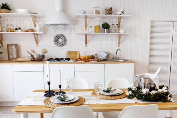istock Modern new light interior of kitchen with white furniture and dining table 1073514252