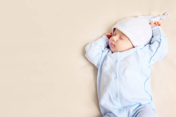 istock Cute baby sleeping on bed 1073525156
