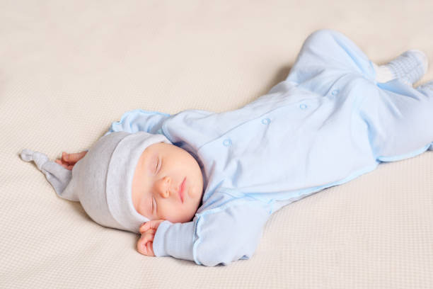 istock Cute baby sleeping on bed 1073525326