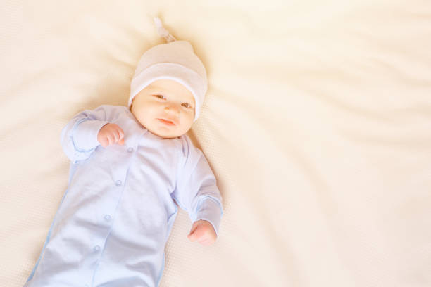 istock Baby in pajamas lying on bed 1073525350