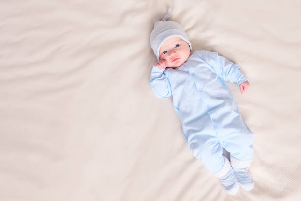 istock Baby in pajamas lying on bed 1073525358