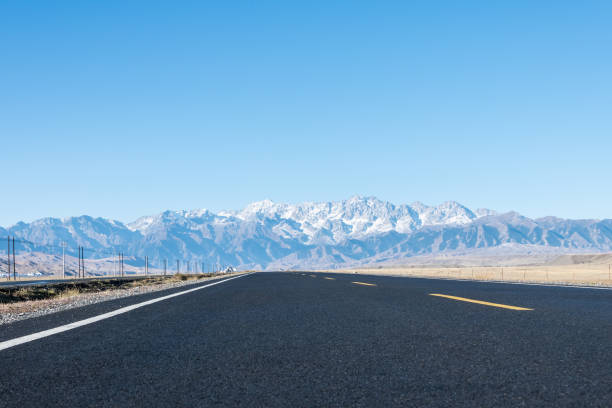 istock road on wilderness and snow mountains 1073531862