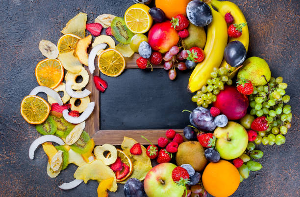 istock dried and raw fruits on dark background 1073550790