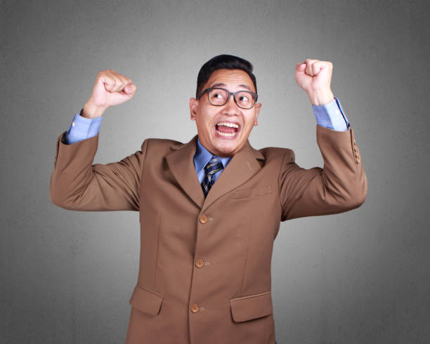 istock Young Businessman Winning Gesture 1073551426