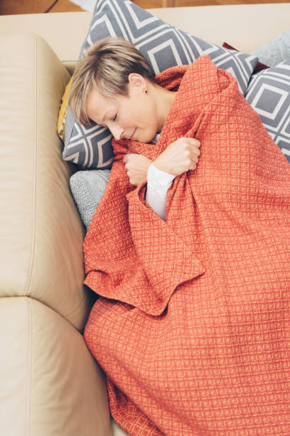 istock Attractive woman dozing on a sofa 1073559062